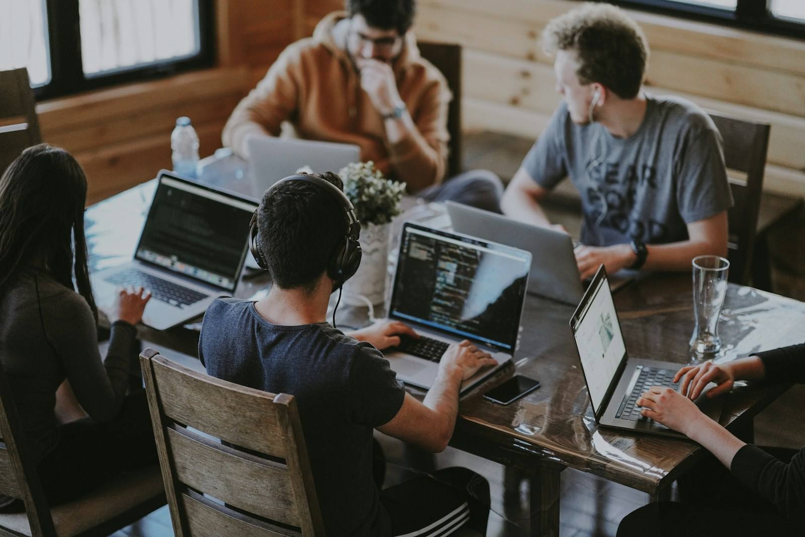 Colleagues collaborating around a table in a bright office