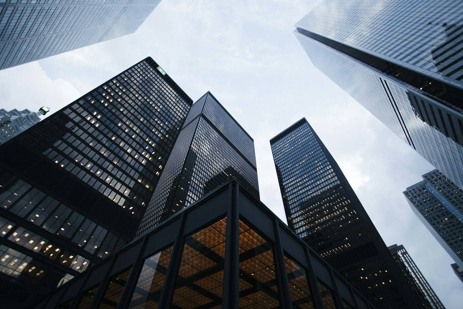 A modern glass office tower rising above a city street