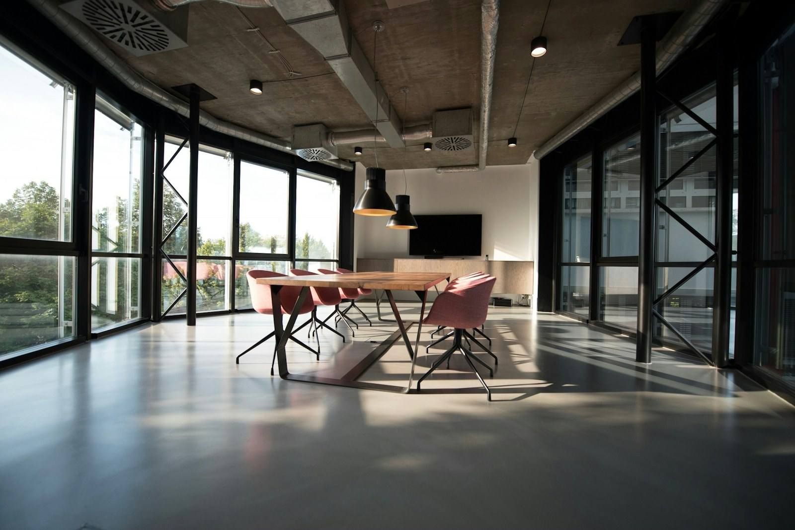 A bright office workspace with desks and computers in a modern building