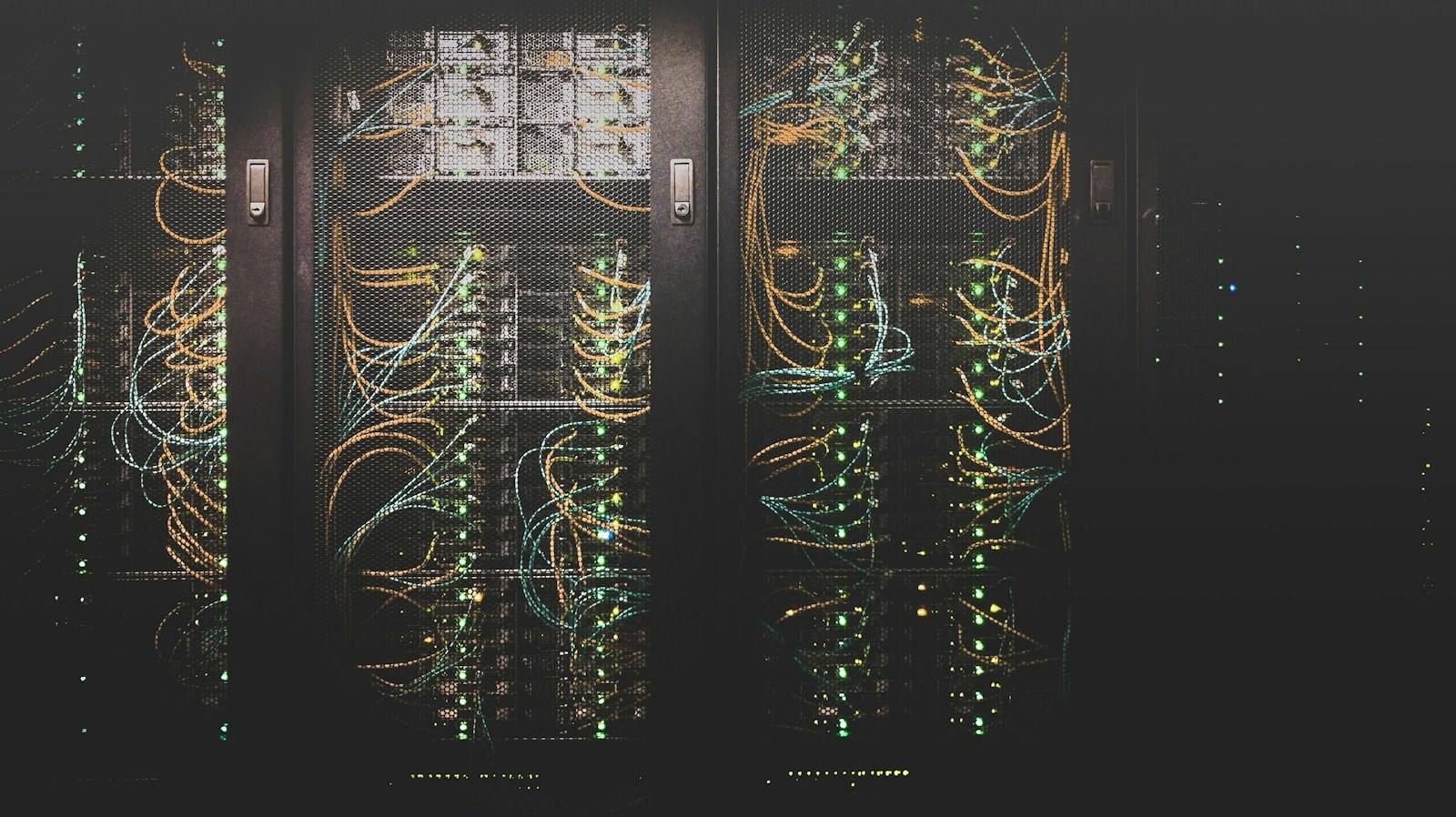Rows of illuminated server racks in a data center supporting platform operations